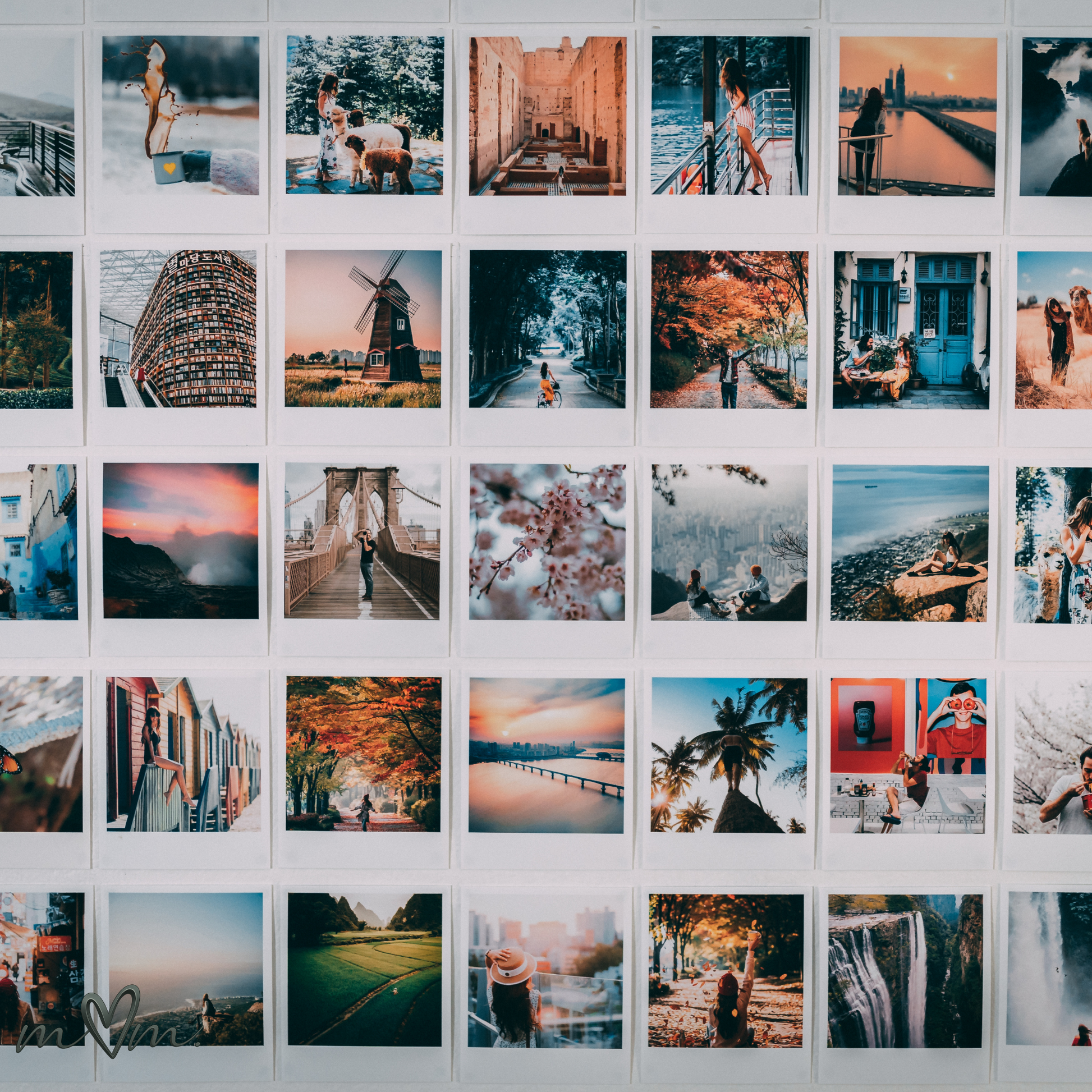 Grid of various photos on a wall, including landscapes and people.