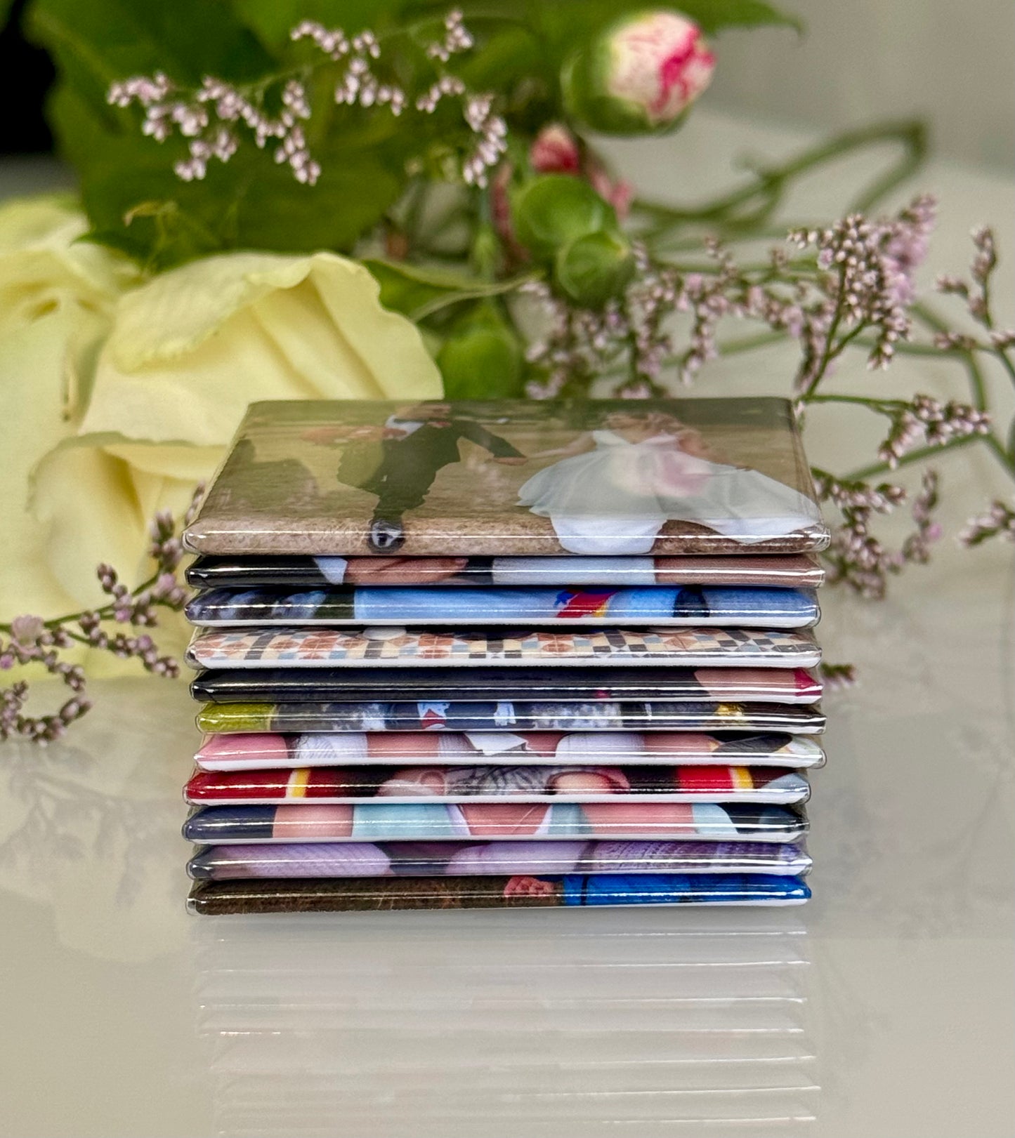 Stack of photo albums with floral and decorative elements in the background