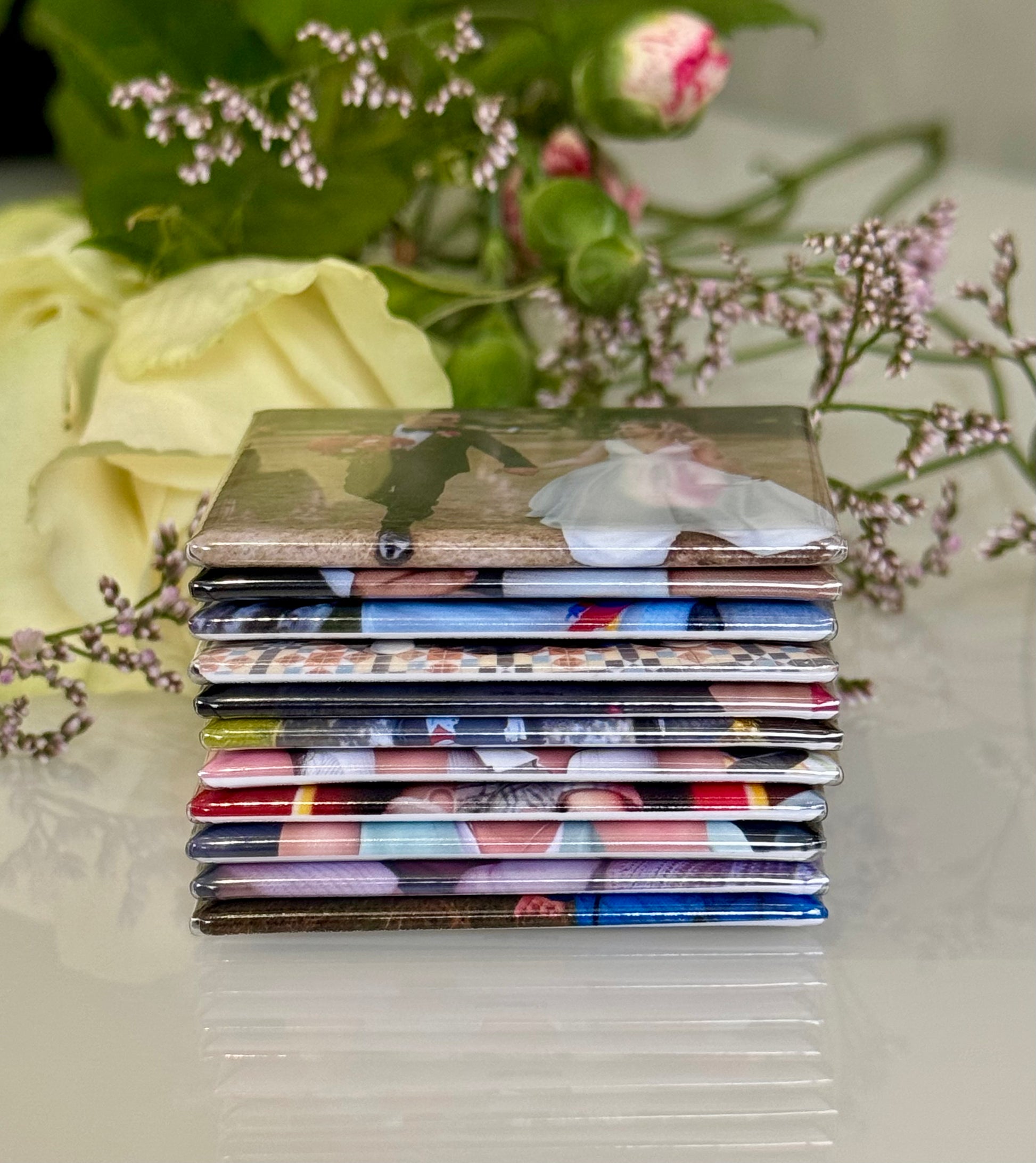 Stack of photo albums with floral and decorative elements in the background