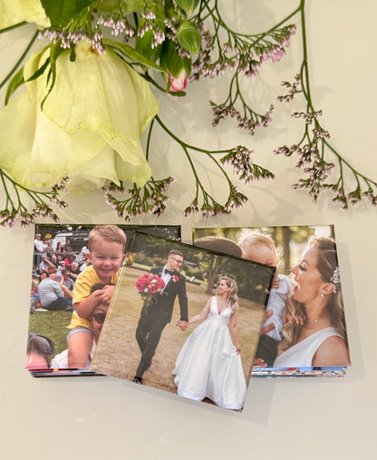 Three photo prints of a couple and a child, with flowers on a light background